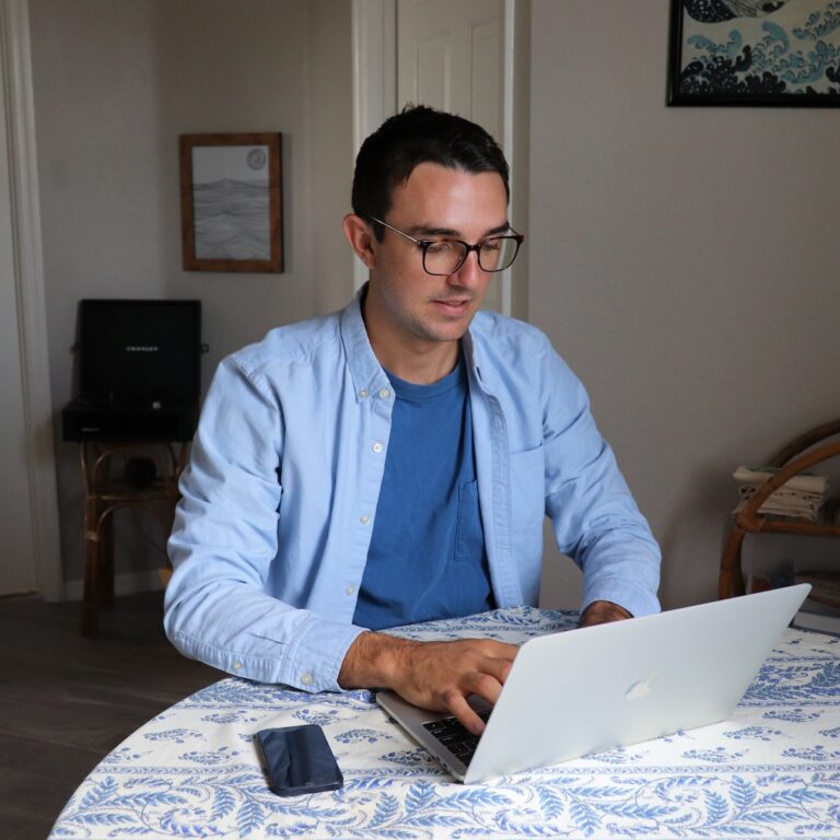 man in white dress shirt wearing black framed eyeglasses